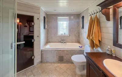 a bathroom with a tub and a toilet and a sink at Stunning Home In Etnedal With Sauna in Etnedal