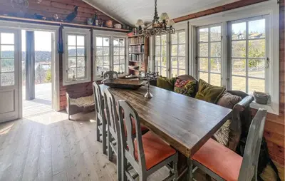 a living room with a wooden table and a couch at Stunning Home In Etnedal With Sauna in Etnedal