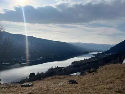 a view of a lake in the middle of a mountain at Architect designed sleeping box in barn in Nos