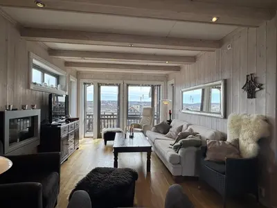 a living room with a couch and a table at Ski-in ski-out at Kikut, Geilo, apartment with sauna in Geilo