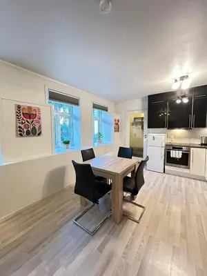 a kitchen and dining room with a table and chairs at Apartment in the Heart of Ålesund in Ålesund