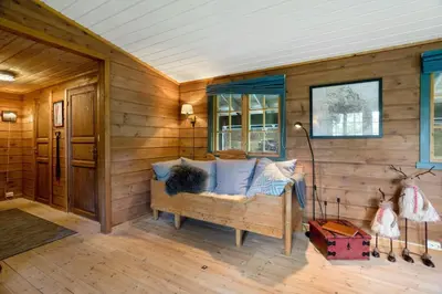 a room with a couch in a wooden wall at Mountain Cabin With Cross-Country Trails In Rauland in Rauland
