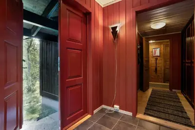 a hallway of a house with red walls at Mountain Cabin With Cross-Country Trails In Rauland in Rauland