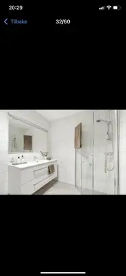 a white bathroom with a shower and a sink at Rom i nyere rekkehus nord i Haugesund in Haugesund