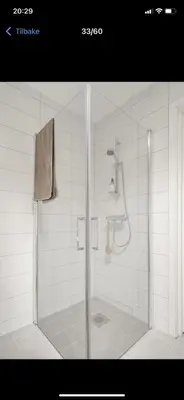 a shower with a glass door in a bathroom at Rom i nyere rekkehus nord i Haugesund in Haugesund