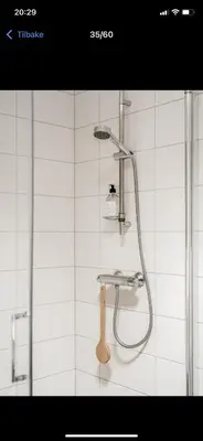 a shower with a shower head in a bathroom at Rom i nyere rekkehus nord i Haugesund in Haugesund