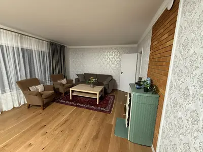 a living room with a couch and a table at A comfy House in Hol