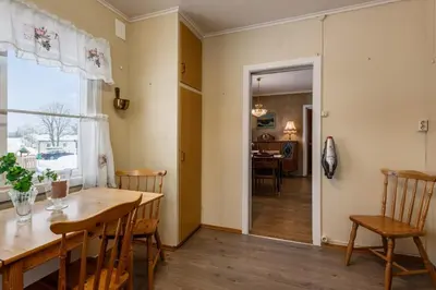 a dining room with a wooden table and chairs at A comfy House in Hol