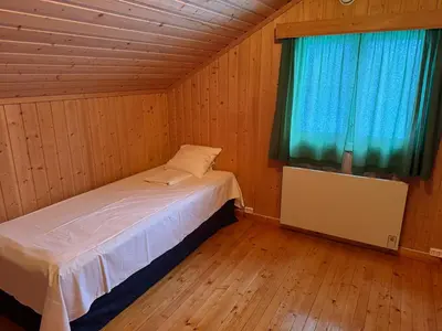 a small bedroom with a bed and a window at A comfy House in Hol