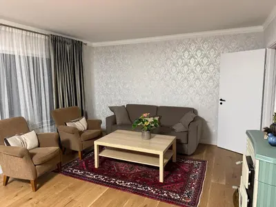 a living room with a couch and chairs and a table at A comfy House in Hol
