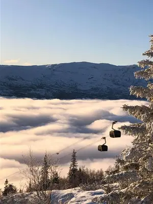 a pair of ski lifts flying over a snow covered valley at Apartment with a view at Bavallen Tråstølen Voss in Vossevangen