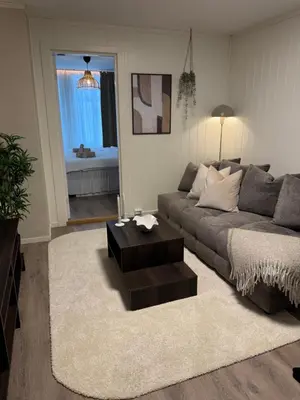 a living room with a couch and a coffee table at Bo i Bergens eldste smau på Nøstet - sentralt og rolig in Bergen