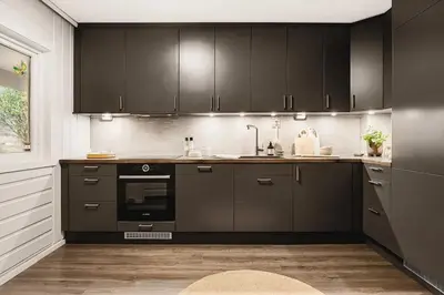 a kitchen with black cabinets and an oven at Spacious 3 Bedroom Townhouse in Bergen