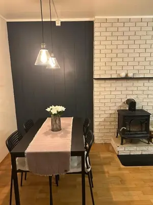 a dining room with a table with a vase of flowers at Spacious 3 Bedroom Townhouse in Bergen