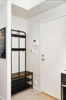 a room with a white wall and a door at DINBNB Apartments l 100m to Bryggen l Pet Friendly l Sleeps 4 l Smart-TV in Bergen