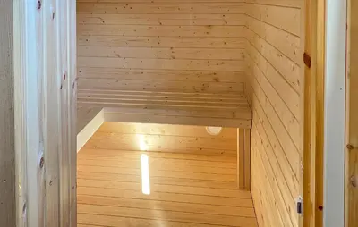 an empty sauna with a wooden floor in a room at Knausen in Ørsta