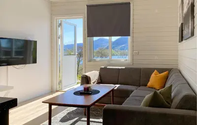 a living room with a couch and a table at 2 Bedroom Gorgeous Home In Ørsta in Ørsta