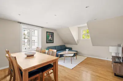 a living room with a table and a couch at Historic Bergen Home I Free Parking in Bergen
