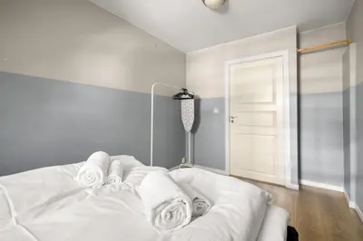 a bedroom with a white bed with towels on it at Historic Bergen Home I Free Parking in Bergen