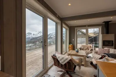 a living room with a view of a snowy mountain at Mountain View Lodge in Stranda