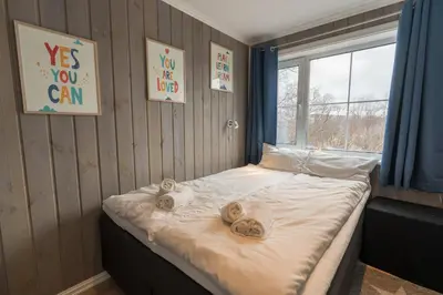 a bedroom with a bed with towels on it at Mountain View Lodge in Stranda