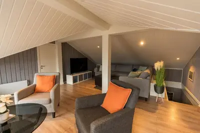 a living room with two chairs and a couch at Mountain View Lodge in Stranda
