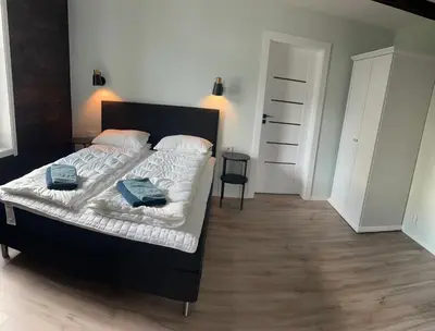 a bedroom with a bed with two pillows on it at Husslåttene apartments 2 in Skei