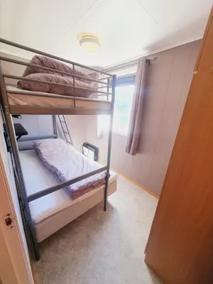 two bunk beds in a room with a window at Leilighet i Røldal in Håra
