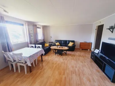 a living room with a couch and a table at Leilighet i Røldal in Håra