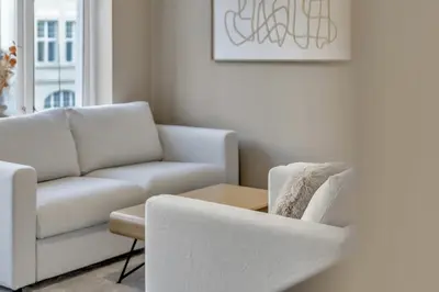 a living room with a couch and a chair at Bryggen Gateway Homes in Bergen