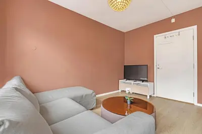 a living room with a couch and a table at Bryggen Gateway Homes in Bergen