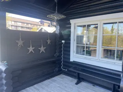 a room with a bench next to a window at Log Cabin With Mountain View in Beitostøl