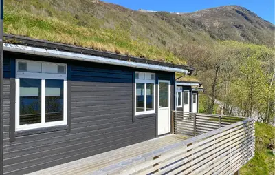a house with a grass roof with a wooden deck at Amazing Home In Ørsta With Wifi in Ørsta