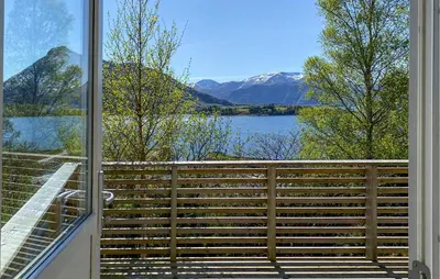 a balcony with a view of a lake and mountains at Amazing Home In Ørsta With Wifi in Ørsta