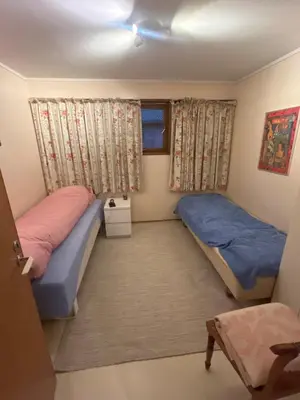 a bedroom with two beds and a window at 4 bedroom room House in Beautiful Strandebarm in Kvam
