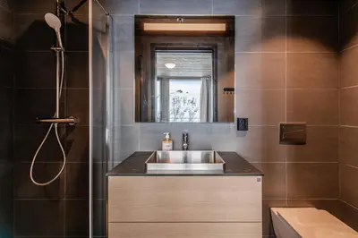 a bathroom with a sink and a shower at Kikut Alpin Lodge 1301 in Hol