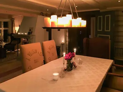 a table with candles and a vase of flowers on it at Charming Log Cabin With Modern Luxury in Dagali