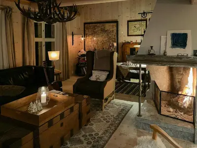a living room with a couch and a fireplace at Charming Log Cabin With Modern Luxury in Dagali