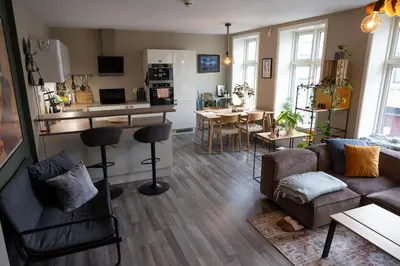 a living room with a couch and a dining room at Big apartment in central Aalesund in Ålesund
