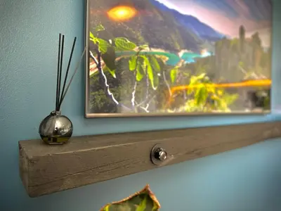 a picture hanging on a wall with a vase on a shelf at Cozy basement apartment in Ålesund