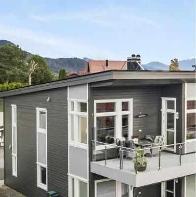 a house with a balcony with two dogs on it at Panoramic View & Comfort in Ålesund
