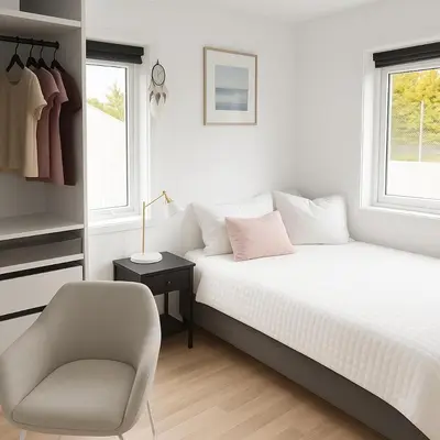 a white bedroom with a bed and a chair at Panoramic View & Comfort in Ålesund