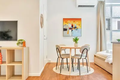 a small dining room with a table and chairs at Heimby - Roomy Studio w Free parking and SeaView in Bergen