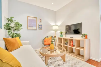 a living room with a couch and a table at Heimby - Roomy Studio w Free parking and SeaView in Bergen