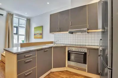 a kitchen with stainless steel appliances and a counter top at Heimby - Roomy Studio w Free parking and SeaView in Bergen