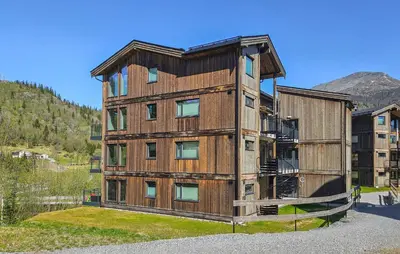 a large wooden building with a roof at Stunning Apartment In Hemsedal in Hemsedal