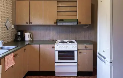 a kitchen with a white stove and a refrigerator at Awesome Home In Sævareid With Lake View in Sævareid