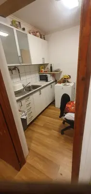 a kitchen with a desk and a chair in a room at Stodio in Lii