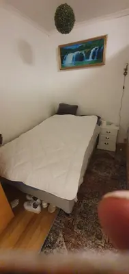 a bed in a room with a white bedspread at Stodio in Lii