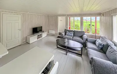 a living room with a couch and a tv at 1 Bedroom Awesome Home In Vik I Sogn in Vikøyri